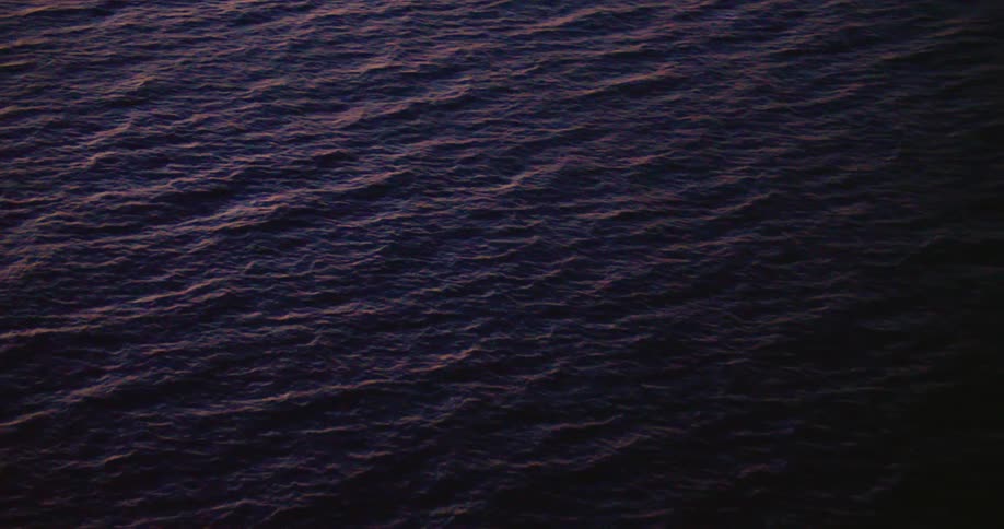 The sun is setting above the ocean