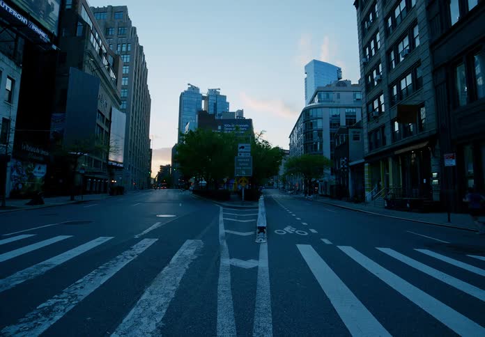 In an urban neighborhood a painted crosswalk spans a city street