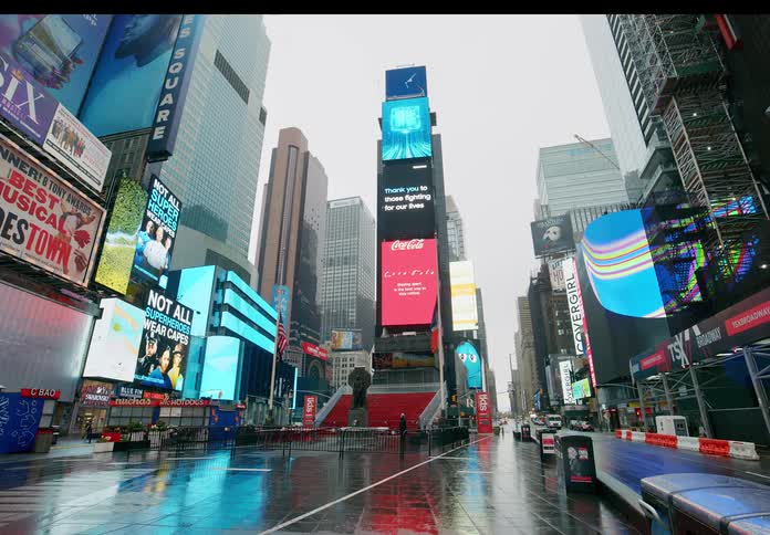 Empty street with tall buildings with billboards in downtown on a cloudy day