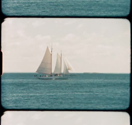 A Two Masted Schooner sails just off the coast of Maine