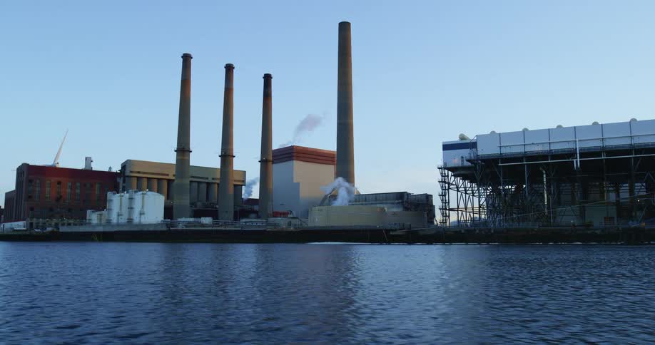 Factory with smokestacks at waterfront