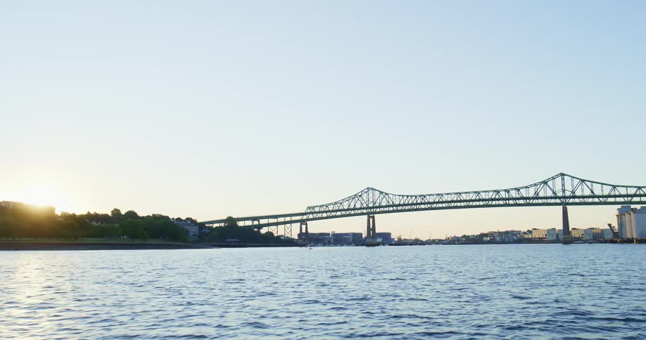 Bridge over a river near a small town at sunset