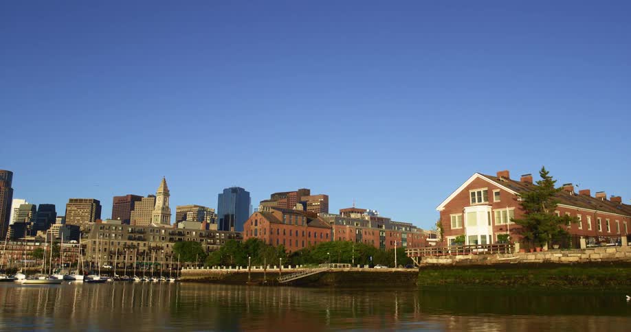 River reflects boats and buildings near downtown skyline