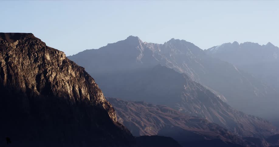 Sunlight shines on rocky mountain ridges