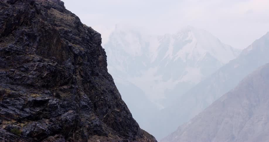 An aerial view of a mountain in winter is displayed