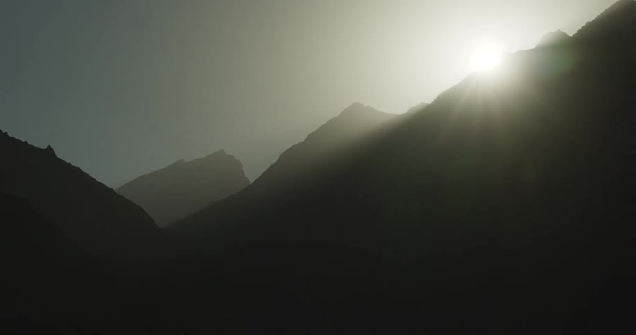 Time lapse of the sun setting over hills