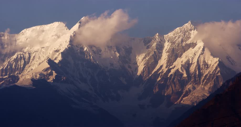 An aerial view of snow covered mountains is displayed