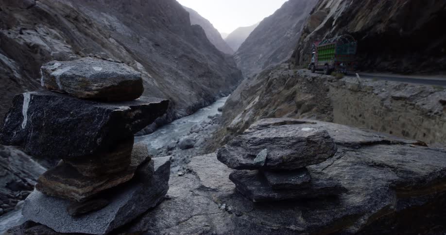 A truck driving on a road in the mountains