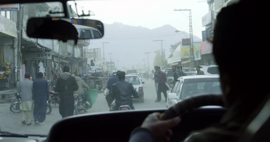 Interior of taxi driving through middle eastern neighborhood street