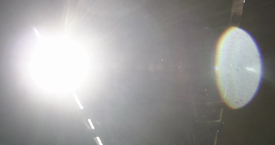 A bright light produces a flare in the dark