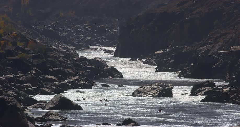 People are riding their canoes down the river