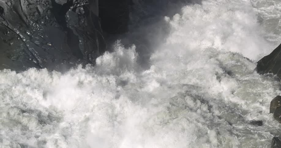 Water crashing against a cliff