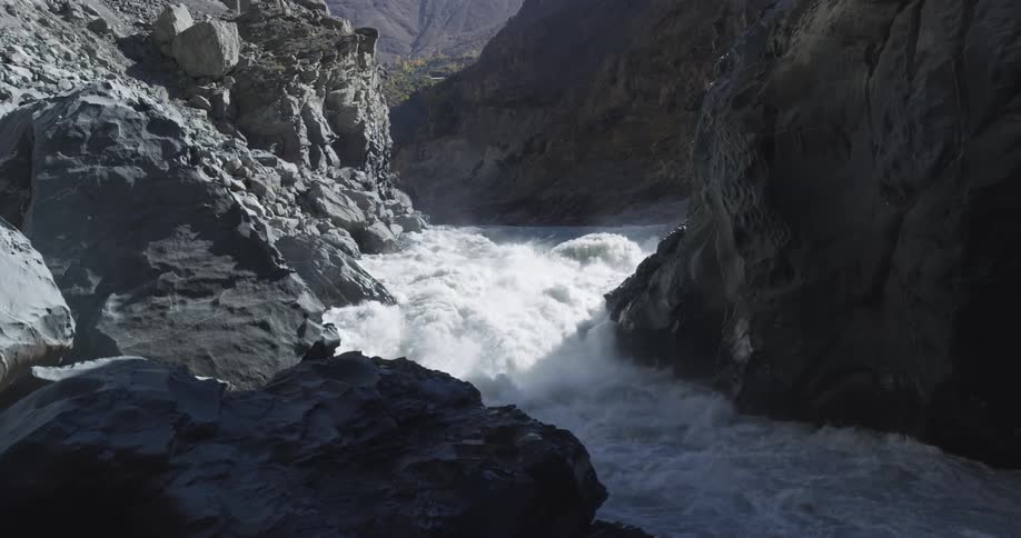 Turbulent waters of a rivers rapid flowing on a narrow canyon