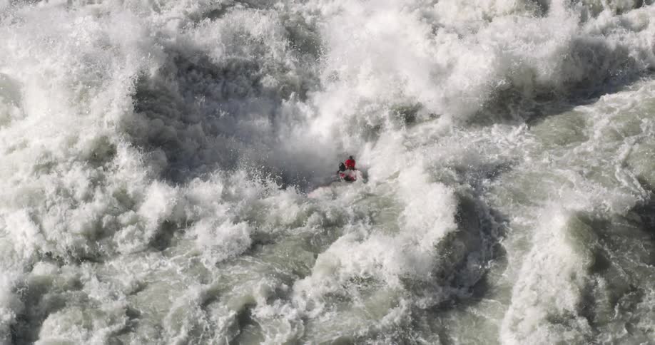 A person kayaking in rapids on a river