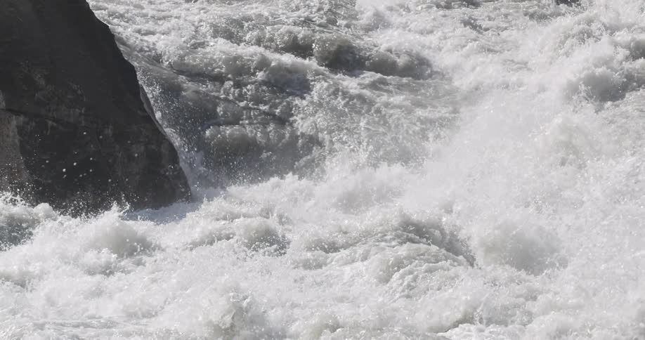 River water gushing over a rapid in the daytime