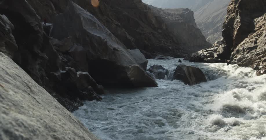 Turbulent waters on a river rapids in a canyon in the mountains