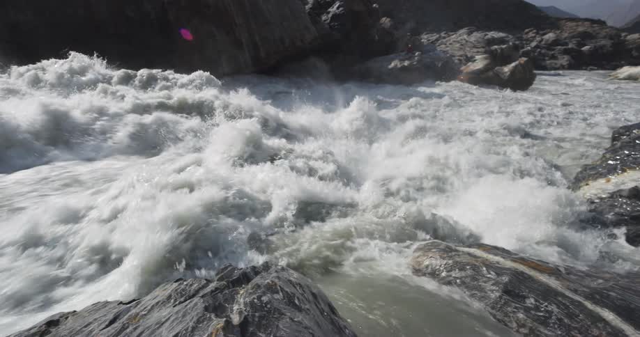Whitewater rushes and splashes over rock