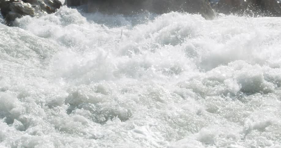Person in kayak navigates intense whitewater rapids