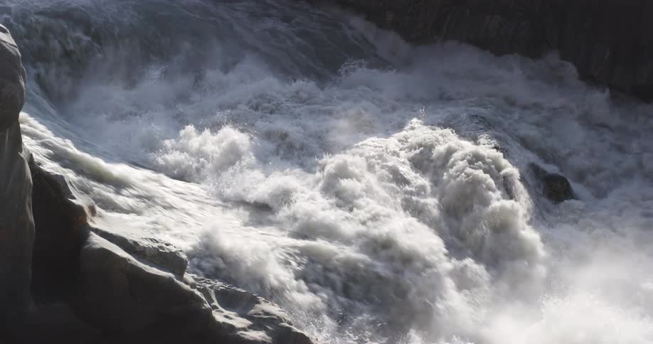 Turbulent waters splashing over the rocks of a rivers rapid