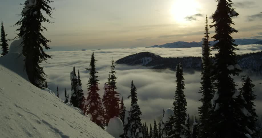 Clouds floating over a snowy mountain landscape on a winter day