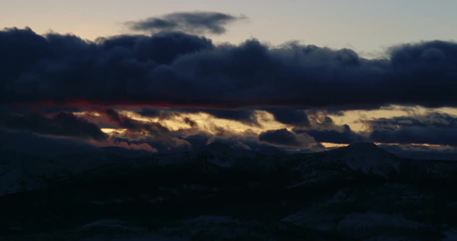 Time lapse of clouds passing over the snow covered mountain range