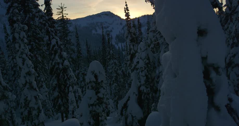 An aerial view of a snow covered mountain is displayed