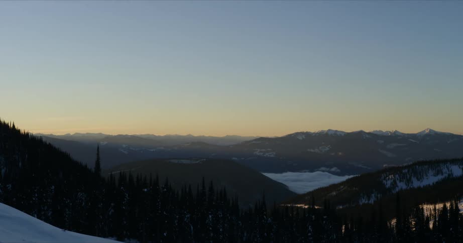 Time lapse of clouds running on the valley on the mountains at sunrise