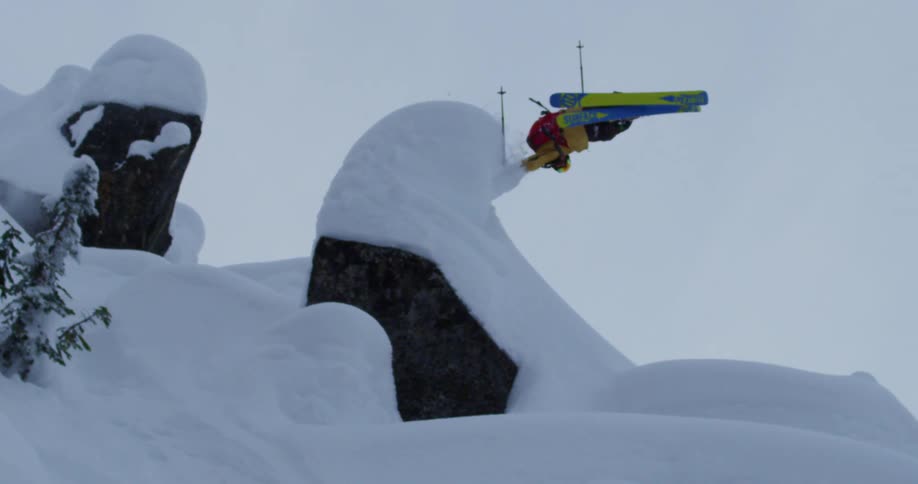 A person jumps as they ski down a mountain
