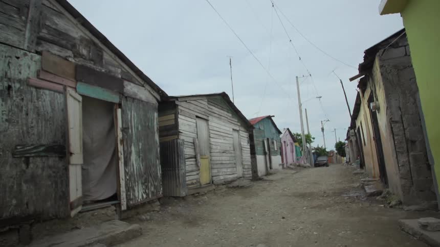 Moving down an alley with small sheds on both sides