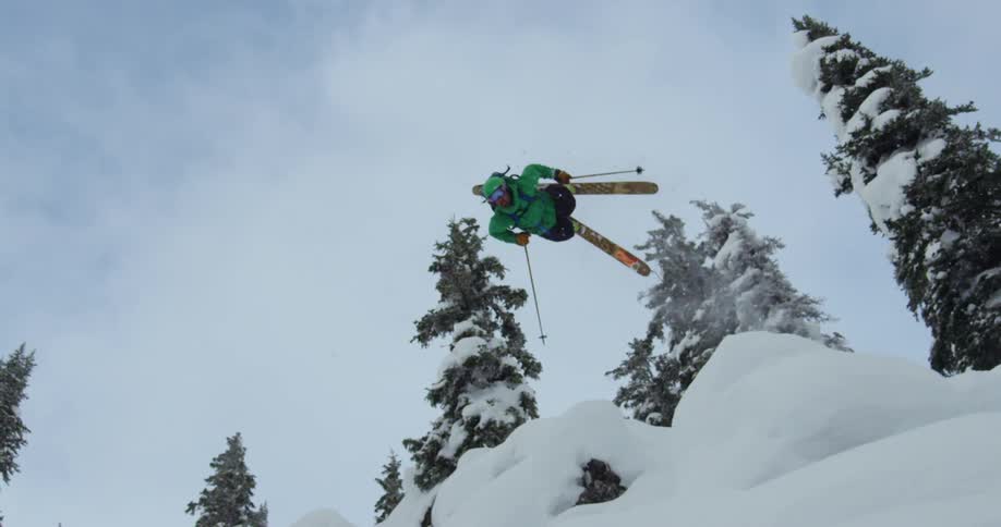 A man skiing flips in the air