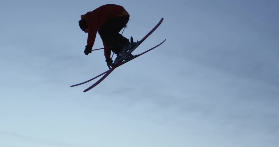 A person jumps as he skis down a mountain