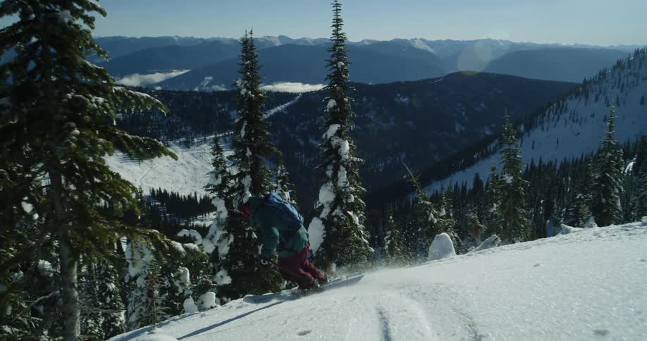 A skier gliding down a snowy mountain on a winter day