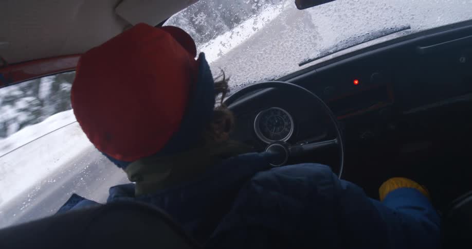 A man is driving on a dangerous icy highway