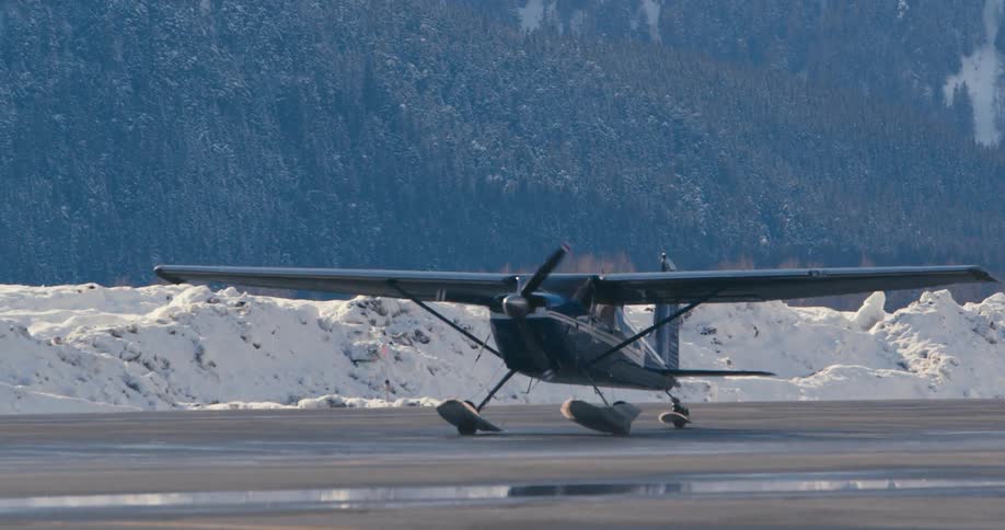 An airplane driving on pavement