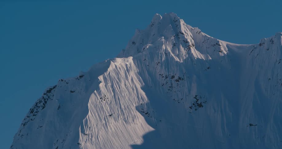 A snowy mountain range on a winter day