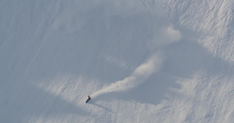 Skier sliding down the steep slopes of a snow covered mountain