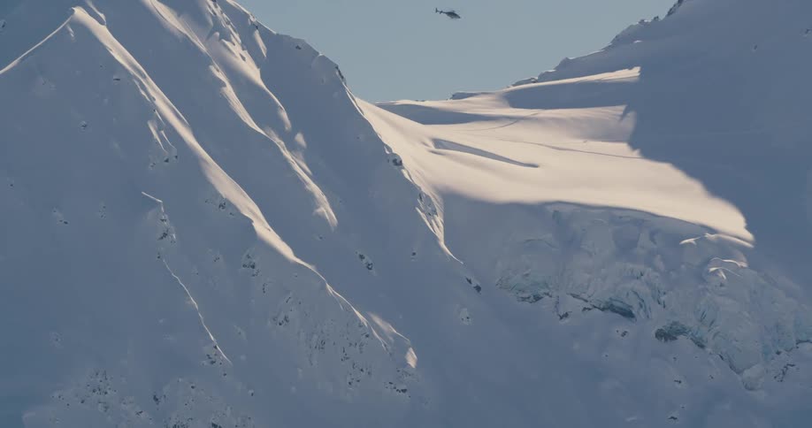 A helicopter is flying near an arctic area