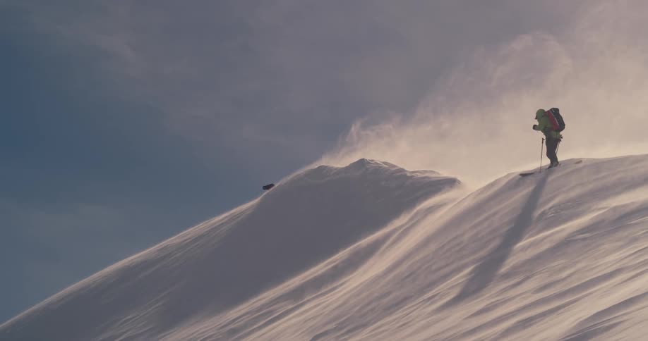 A person is skiing on a mountain in winter