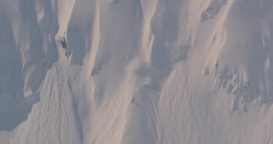 A person skiing down a snow covered mountain
