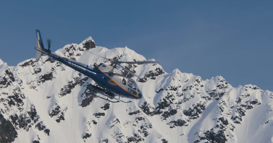 A helicopter is flying above an arctic area