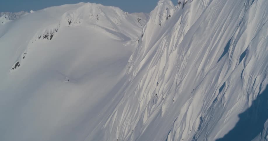 A skier skiing down a snowy slope