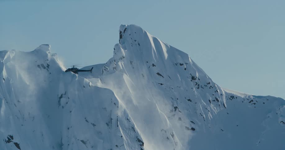 A helicopter is flying through an arctic area