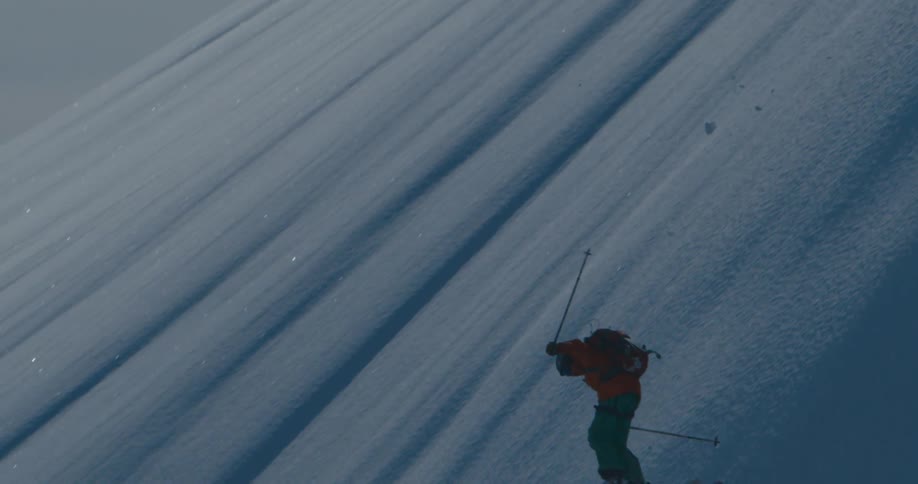 Skier jumps and spins managing to stay on their feet after landing