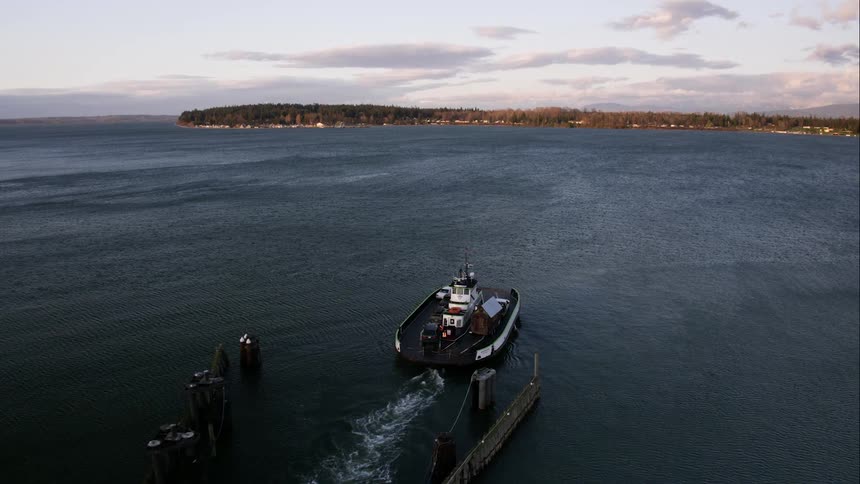 A vehicle ferry leaves the terminal and heads to sea