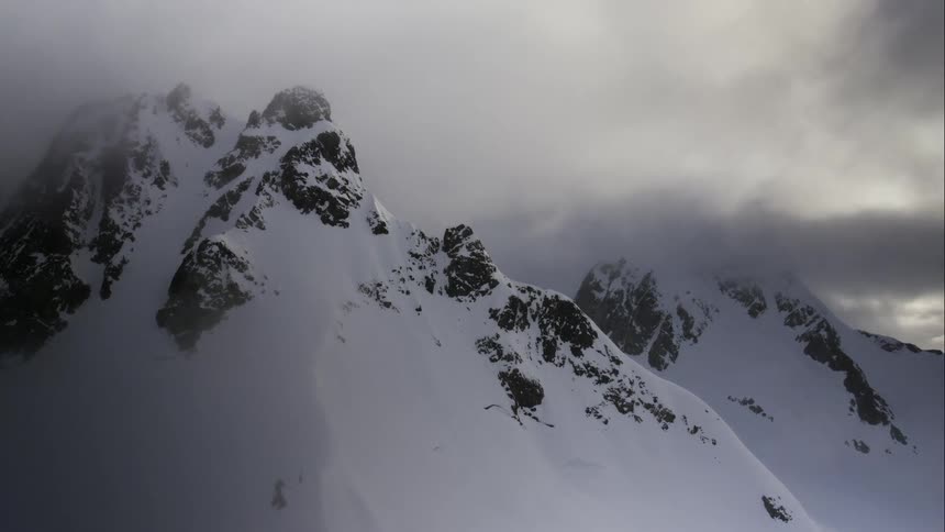 Aerial of glacial mountains in the mist