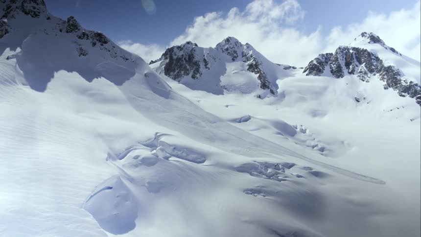 Aerial view of snowy mountains and an old avalanche