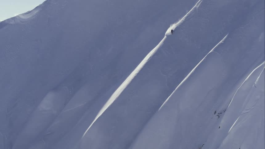 Aerial of a skier on an extreme steep mountain