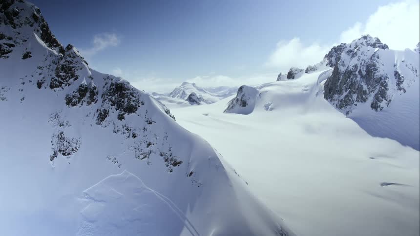 Aerial wrap around a snow covered mountain and an old avalanche