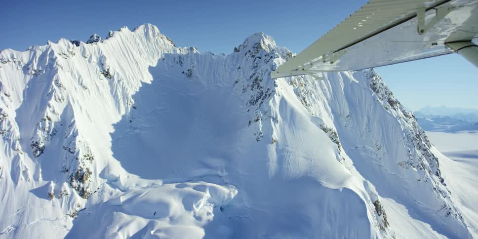 Aerial view of snow capped mountains seen from a plane