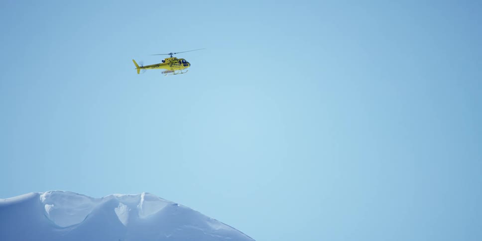 A helicopter in flying above an arctic area